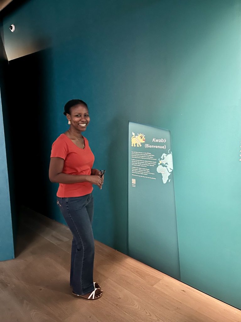 The author standing at the entrance of the "Bénin Aller-Retour" exhibition at Musée Albert-Kahn, ready to explore the history of Dahomey. A must do in Paris.
